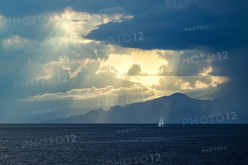 Sun rays in the clouds over Sicily, Tyrrhenian Sea, Italy
