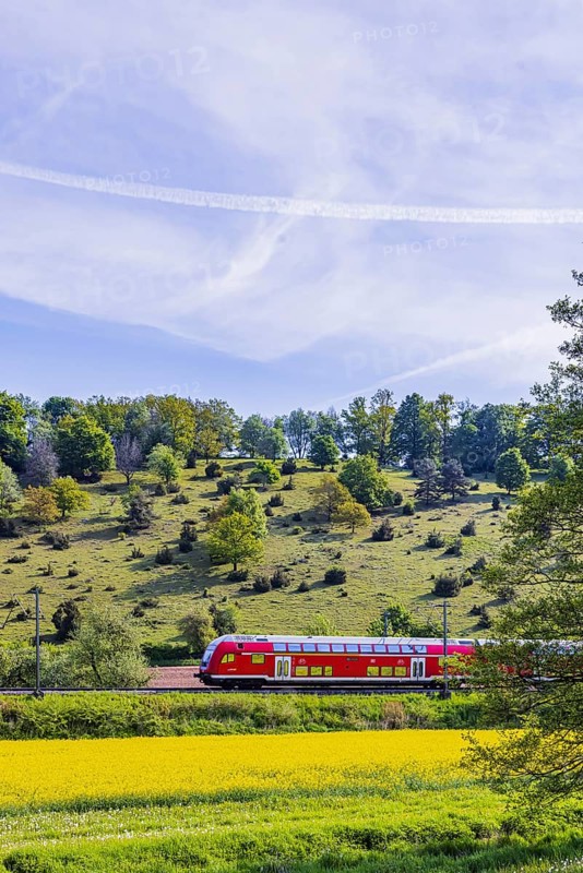 RegionalExpress RE5 to Friedrichshafen travelling over the Swabian Alb. Idyllic landscape near Lonsee in spring. Lonsee, Baden-Württemberg, Germany
