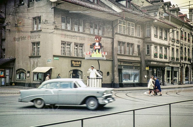 Chevrolet car passes a policeman directing traffic in the city of Bern, Switzerland, Europe 1961