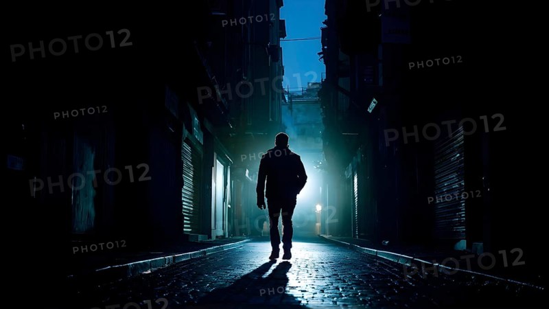 Man fleeing down a narrow dimly lit alleyway urban setting at nighttime, AI generated