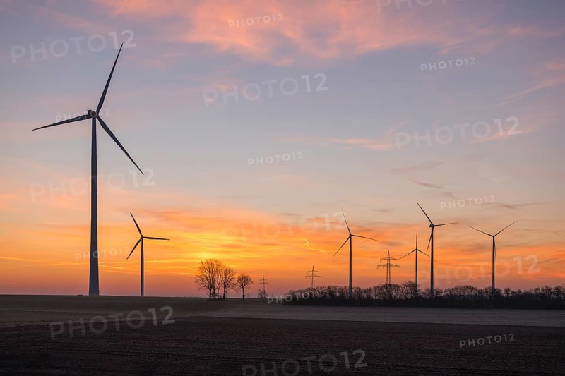 Wind farm at sunset, the sky is bathed in soft pink and orange, near Ulm, Swabian Alb, Baden-Württemberg, Germany