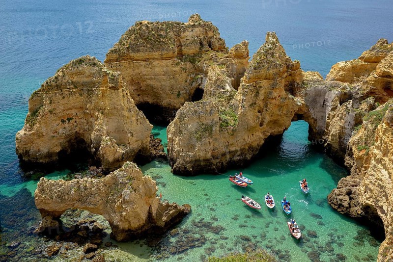 Excursion boats on the rocky coast near Lagos, Algarve, Portugal