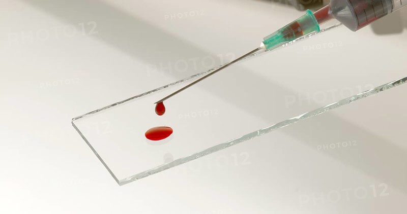 Blood dropping from Needle against White Background