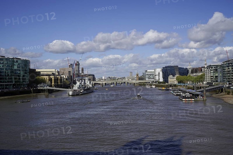 View of the River Thames from Tower Bridge in the City of London with bridges and modern architecture under a blue sky, London SE1 2UP, England, United Kingdom