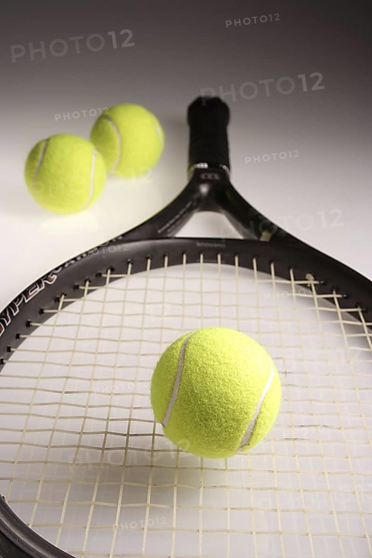 Tennis balls three green color with tennis racket racquet