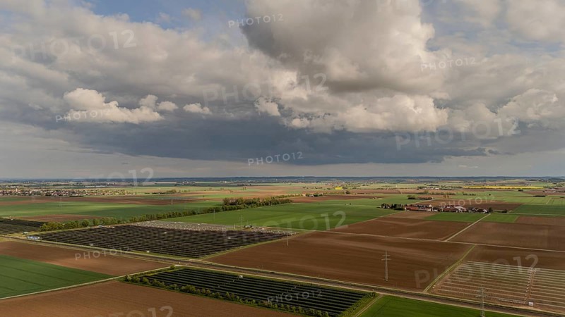 Landscape with wide fields and dramatic clouds in the sky, Straubing, Lower Bavaria, Germany