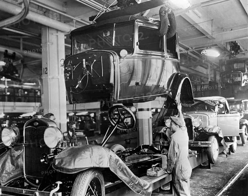 Ford history. It's factory in Highland park Michigan USA was a production facility for the Model T car and has become known for being the first factory in history to assemble cars on a moving assembly line. In 1927 the new model A was in production and the picture taken that year shows the assembly line with bodies and chassis being assembled by factory workers