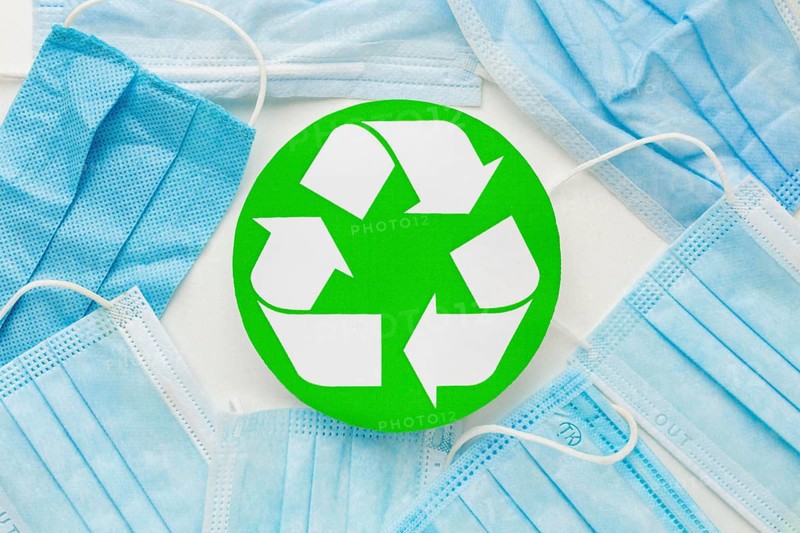 Top view disposable medical masks recycle symbol