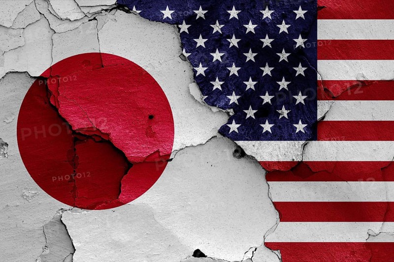 Flags of Japan and USA painted on cracked wall