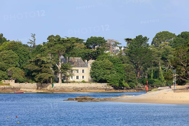 Coast of Combrit, district Le Moguer with historic villa by the sea, seen from Benodet, department Finistere Penn ar Bed, region Bretagne Breizh, France