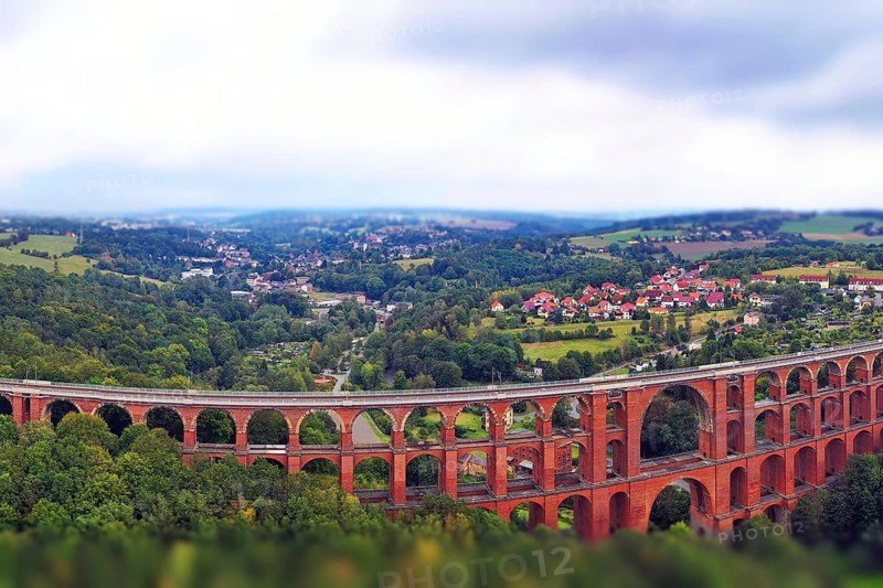 Aerial view of the Göltzsch Valley Bridge, an impressive brick viaduct that spans majestically over the Göltzsch valley. The bridge consists of several arches and is the largest brick bridge in the world. Mylau, Reichenbach, Netzschkau, Saxony, Germany