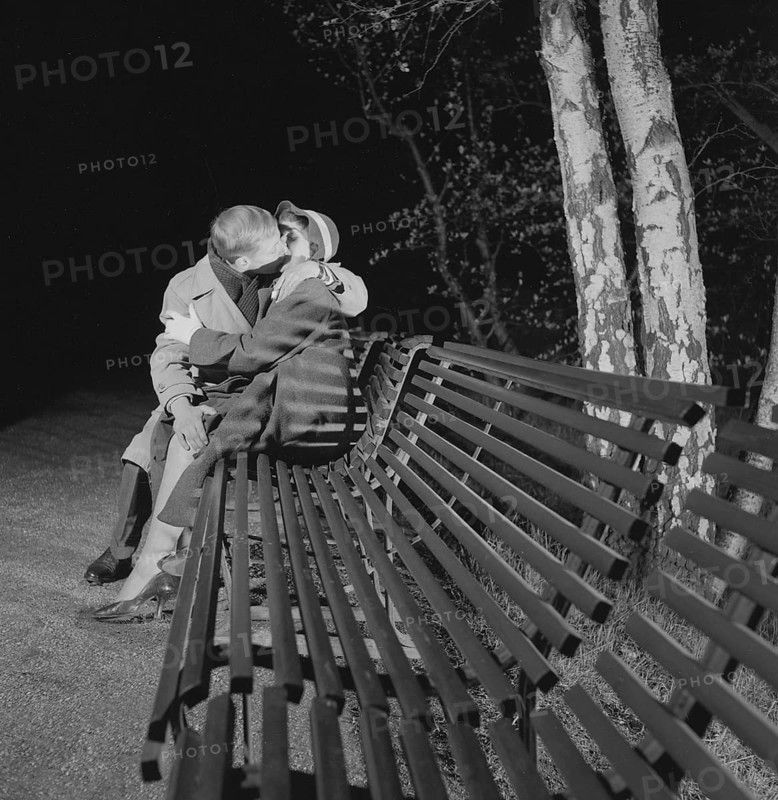 In the 1950s. A young couple is sitting on a bench kissing. A date ending pretty well. Sweden 1953 Conard ref 2402