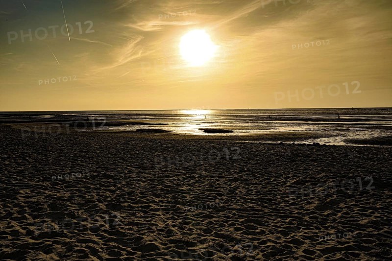 Golden sunset creates a warm atmosphere on a sandy beach, North Sea beach 27476 Cuxhaven/Sahlenburg-Germany