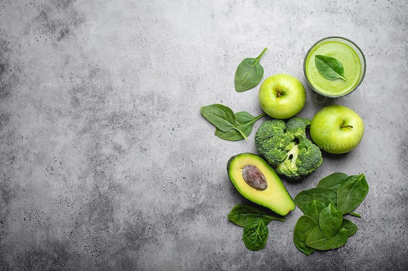 Ingredients for making green healthy smoothie with broccoli, apples, avocado, spinach, stone background. Clean eating, detox plan, diet, weight loss concept. Close up, top view, space for text