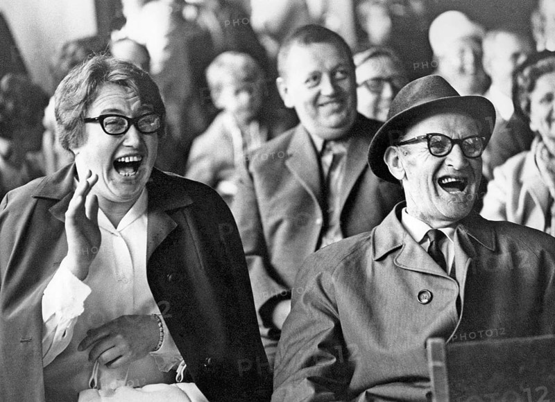 Audience in the 1960s. They are all laughing at something or someone on the stage. Sweden 1960s