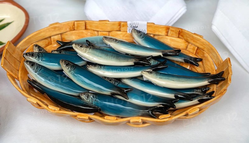 Bowl of pottery ceramic fish sardines in gift shop, city of Guimaraes, northern Portugal