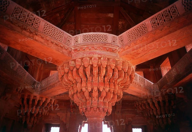 The Diwan-i-Khas, or Hall of Private Audience, is a plain square building with four chhatris on the roof. It is famous for its central pillar, which has a square base and an octagonal shaft, both carved with bands of geometric and floral designs, further its thirty-six serpentine brackets support a circular platform for the Mughal emperor Akbar, which is connected to each corner of the building on the first floor, by four stone walkways. It is here that Akbar had representatives of different religions discuss their faiths and gave private audience.<br/><br/> Fatehpur Sikri (the City of Victory) was built during the second half of the 16th century by the Emperor Akbar (r. 1556-1605). It was the capital of the Mughal Empire for 10 years