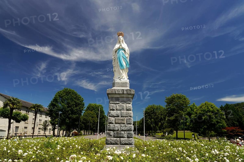 Statue of the Crowned Madonna of Our Lady in Lourdes on Rosary Square in the Marian pilgrimage town of Lourdes, Pyrenees, France