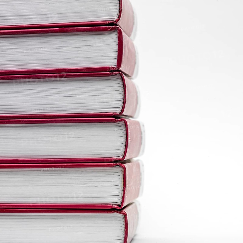 Stacked books with red spines creating a minimalist display against a white background