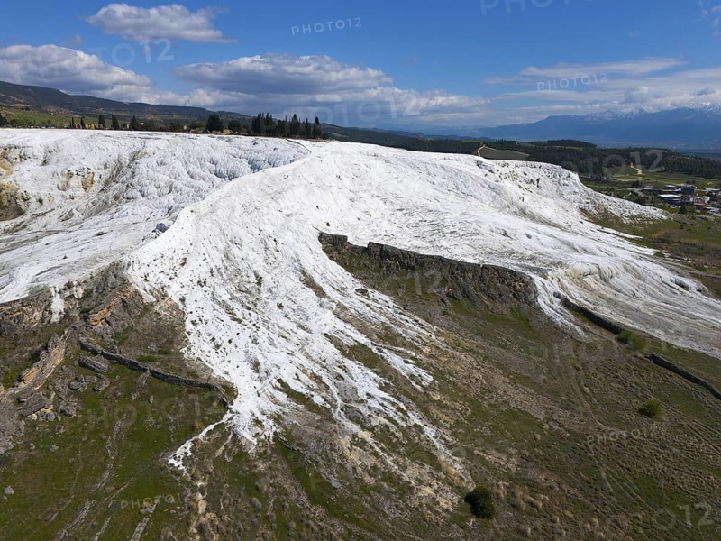 White limestone hills in a natural setting under a blue sky with clouds, aerial view, sinter terraces, limestone sinter terraces, travertine terraces, Pamukkale, Denizli, UNESCO World Heritage Site, Anatolia, Turkey