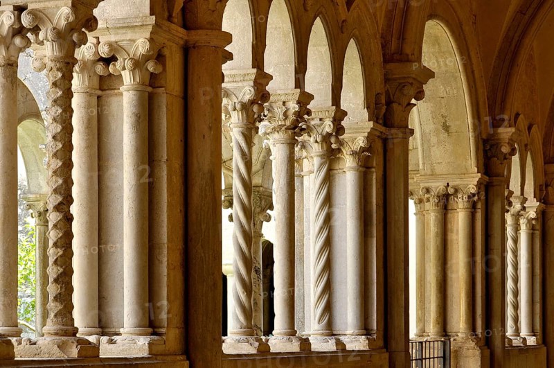 Slender Gothic columns, double columns with filigree capitals in the cloister, Gothic basilica of the Cistercian Abbey of Fossanova, Cistercian-Burgundian architectural style, Priverno, Province of Latina, Lazio, Italy