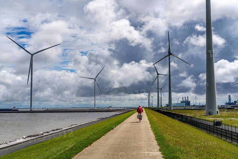 Strekdammen Wind Farm, wind farm at the seaport of Eemshaven in the Netherlands, left, built on offshore breakwaters, 2 GE Cypress 5, 5 MW turbines, with 158 metre blade diameter, together produce 11 MW of power, can supply 15, 500 households with electricity from wind, cumulus cloud over the North Sea, Netherlands