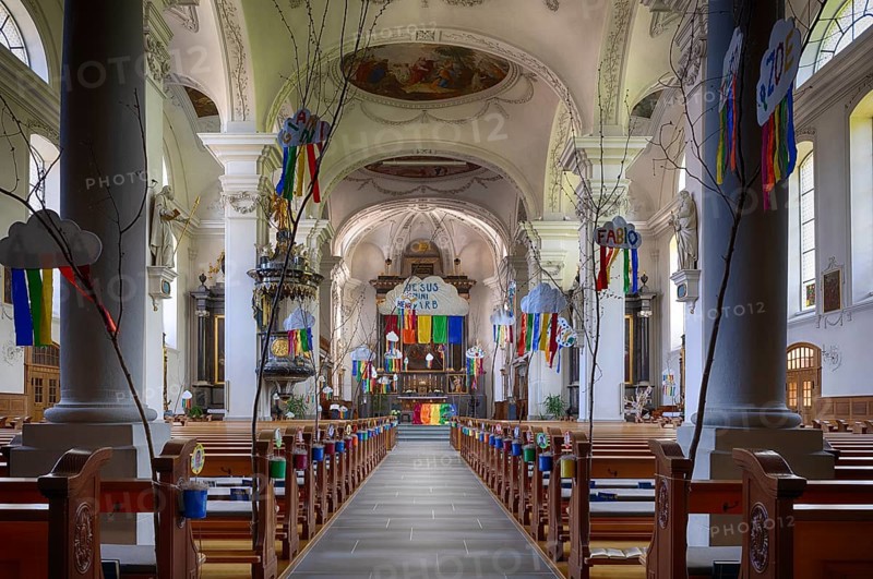 Interior view of nave, choir, altar, Peter and Paul parish church, decorated for First Communion, pillar hall church, Willisau, Canton Lucerne, Switzerland