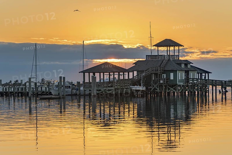 Biloxi Schooner Pier Complex at sunset on the Gulf of Mexico at Biloxi, Mississippi, USA