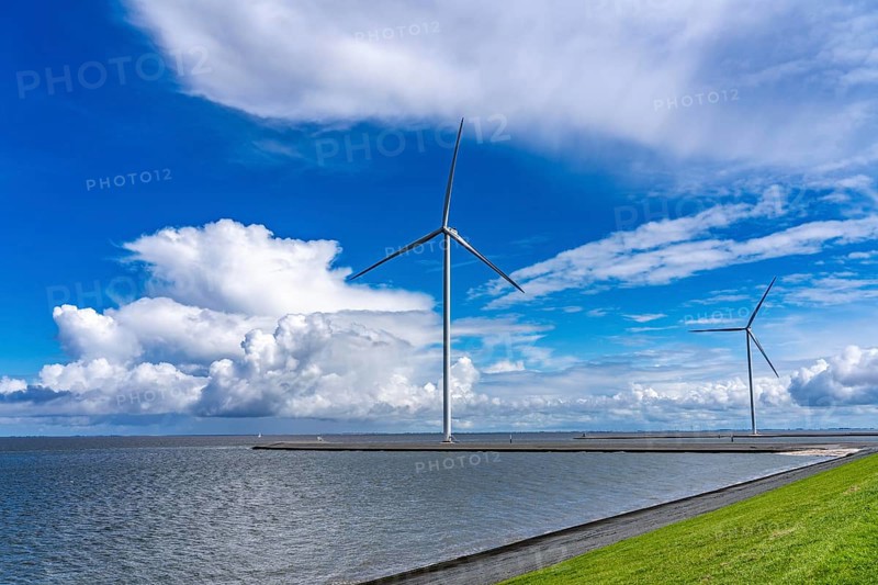 Strekdammen Wind Farm, wind farm at the seaport of Eemshaven in the Netherlands, built on offshore breakwaters, 2 GE Cypress 5, 5 MW turbines, with 158 metre blade diameter, together produce 11 MW of power, can supply 15, 500 households with electricity from wind, cumulus cloud over the North Sea, Netherlands