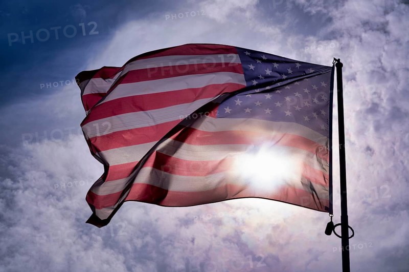 US flag, national flag USA, flies over National Guard memorial, memorial for US soldier Sgt. Frank D. Peregory, recipient of the Medal of Honour, backlight, Grandcamp-Maisy, D-Day, Operation Overlord, Normandy, Calvados, France