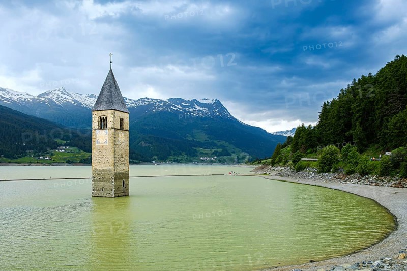Bell tower of the former parish church of St Catherine in the sunken village of Alt-Graun in Lake Reschen in Vinschgau, South Tyrol, Italy