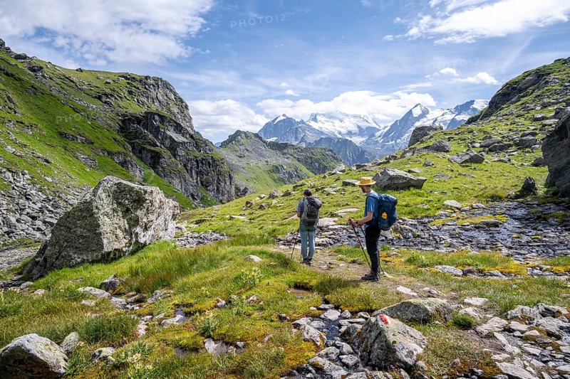 Two mountaineers on a hiking trail in a mountain landscape, descent at Col du Louvie, view of the summit of the Grand Combine, Valais Alps, Val de Bagnes, Valais, Switzerland