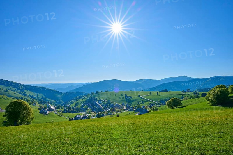 Sunny panoramic view of a village surrounded by green hills under a clear sky, spring, Schauinsland, Hofsgrund, Freiburg im Breisgau, Black Forest, Baden-Württemberg, Germany