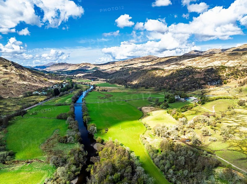 Farms and Mountains over River Dochart and Road A85 from a drone, Perthshire, Scotland, UK
