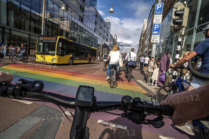 Ride your bike on the central cycle path on Lange Viestraat, Vredenburg, in the city centre of Utrecht, lanes for pedestrians, cyclists and public transport vehicles are separated, heavy cycle traffic, Netherlands