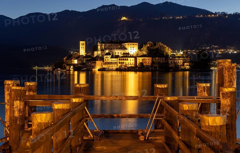 Wooden footbridge with view of Isola San Guilio, Orta San Giulio, on Lake Orta, Province of Novara, Piedmont, Lago d'Orta, Italy