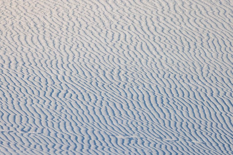 Wind creates wave patterns in the sand dunes at White Sands National Park in Alamogordo, New Mexico, USA