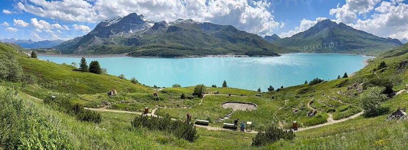 Panoramic view of Lac du Mont Cenis, in the foreground Alpine garden Jardin Alpin next to pass road to pass Alpine pass Mountain pass Col du Mont Cenis Colle del Moncenisio, Mont Cenis massif, Massif du Mont-Cenis, Graian Alps, Lanslebourg, Rhone-Alpes, France