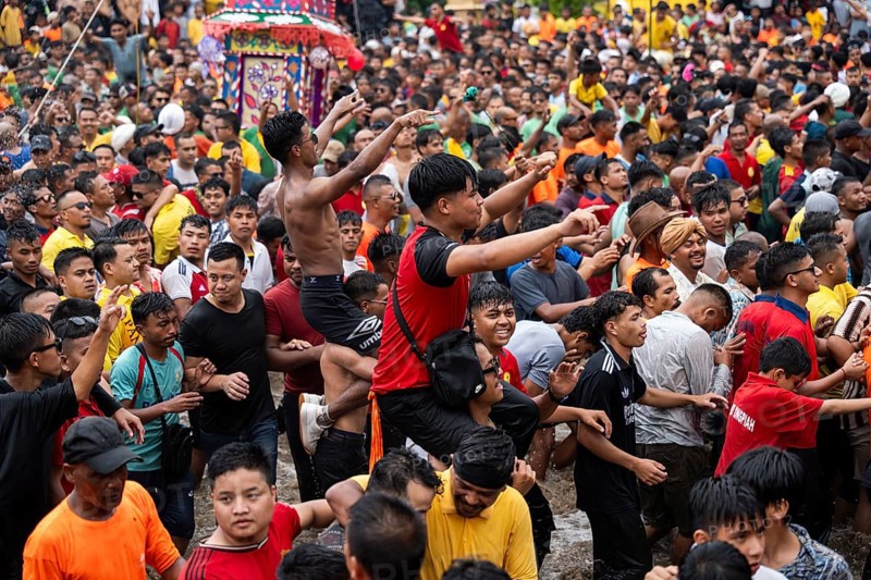 JOWAI, INDIA - JULY 14: People from the Pnar community march in a circle as they celebrate an event organized to mark the Behdienkhlam festival in Jowai, India on July 14, 2025. Behdienkhlam is a vibrant annual festival celebrated by the Pnar (Jaintia) community of Meghalaya, especially in Jowai, to drive away plague and diseases and to pray for a good harvest. Observed in July after the sowing season, it features traditional rituals, offerings to ancestral spirits, and the grand procession of beautifully decorated bamboo structures called rots, which are later immersed in a sacred muddy pool known as Ka Aitnar