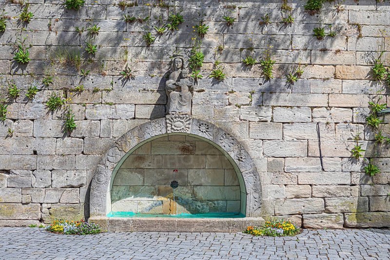 Town wall with a fountain on Marienplatz in Kronach, Germany