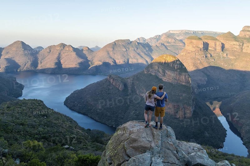 Two hikers enjoying panorama, Blyde River Canyon with Three Rondawels peak, view of gorge with Blyde River and table mountains, canyon landscape, Panorama Route, Mpumalanga, South Africa