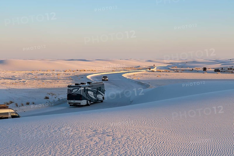 Vehicles being driven on cleared roads through the white gypsum dunes at White Sands National Park in Alamogordo, New Mexico, USA