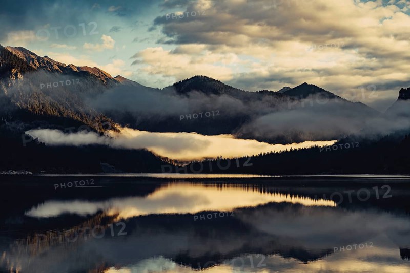 Sunrise with reflections in the Plansee in Tyrol in the Alps in Austria