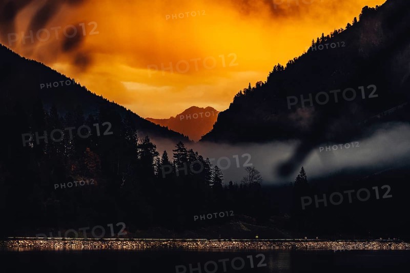 Surreal light atmosphere at sunrise at Plansee, Tyrol, in the Alps in Austria