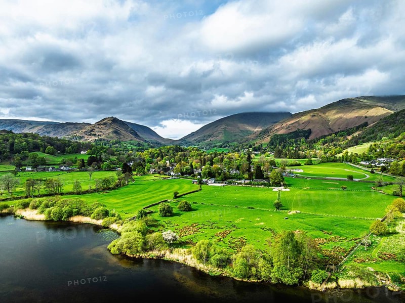 Farms and Mountains over road A591 from a drone, Grasmere Lake, Grasmere, Ambleside, Lake District, Westmorland, Cumbria, UK