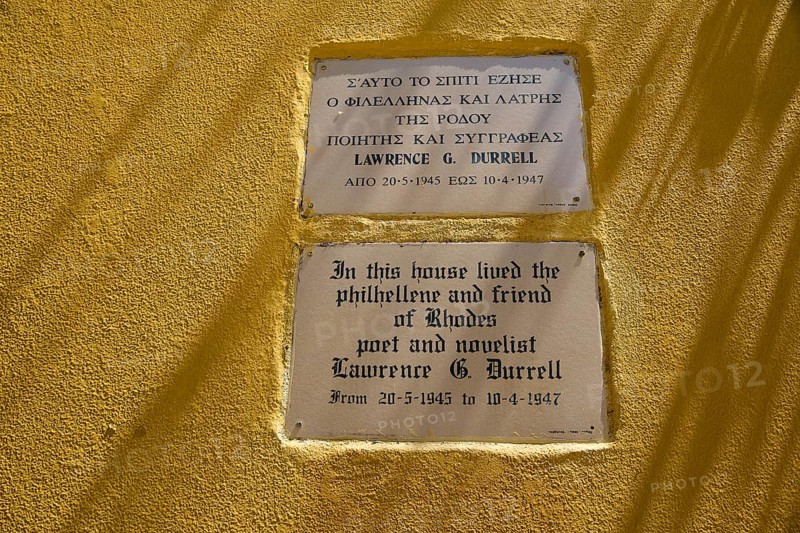 House of Lawrence Durrell, memorial plaques on a yellow wall with quotes by Lawrence G. Durrell, harbour area, Rhodes Town, Rhodes, Dodecanese, Greek Islands, Greece