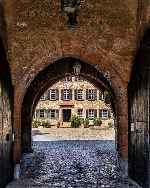 The old castle with Barbarossaplatz and the castle café in the old town centre of Büdingen, Hesse, Germany