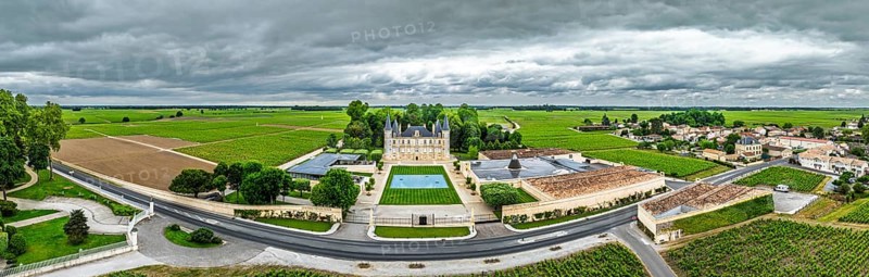 Panorama of Chateau Pichon Longueville Baron Vineyard and grape fields around Pauillac from a drone, Bordeaux, Gironde, Nouvelle-Aquitaine, France