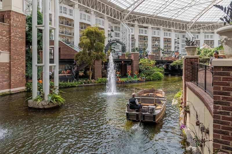 Guide piloting boat through the canal inside the Gaylord Opryland Resort and Convention Center in Nashville, Tennessee