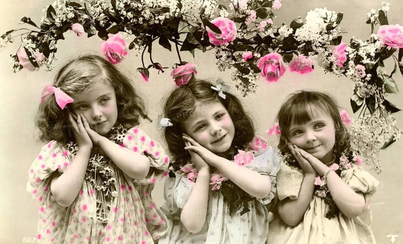 3 girls with flowers, 1900, Three girls in old-fashioned clothes with flowers and pink decorations, Historical photo